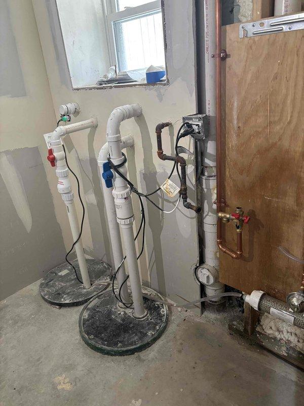 Successfully uninstalled a wall-mounted tankless water heater from a partially finished utility area, disconnecting all copper supply lines and PVC drainage components. Also removed toilet fixture as requested by customer, ensuring proper capping of water lines and waste connections.