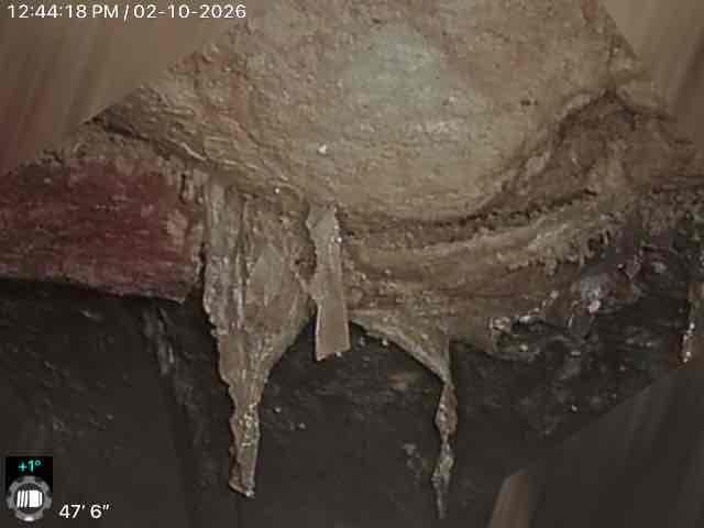 Performed inspection of internal piping system using camera equipment, documenting severe ice formation and blockage within the pipe structure. Images revealed significant moisture damage to surrounding building materials, including possible deterioration of insulation and ceiling materials. Customer was provided with excavation estimate and has requested follow-up discussion regarding options.