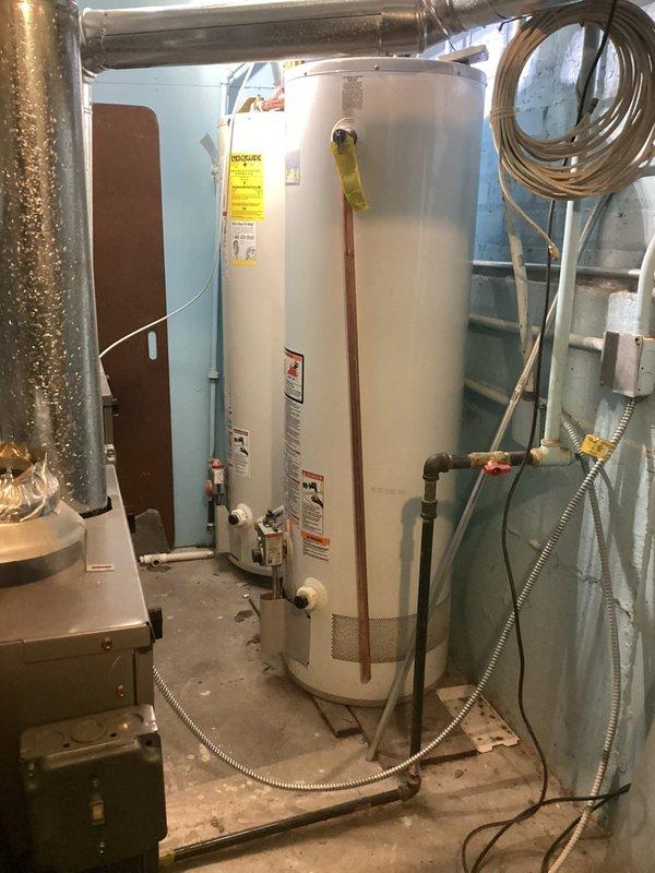 Inspected water heater installation with plastic discharge pipes that require replacement with metal piping per code requirements. Observed current setup includes PVC discharge piping connected to T&P valve, which presents a safety concern due to potential failure under high temperature conditions. Recommended replacement with proper copper or galvanized steel discharge piping to ensure code compliance and system safety.