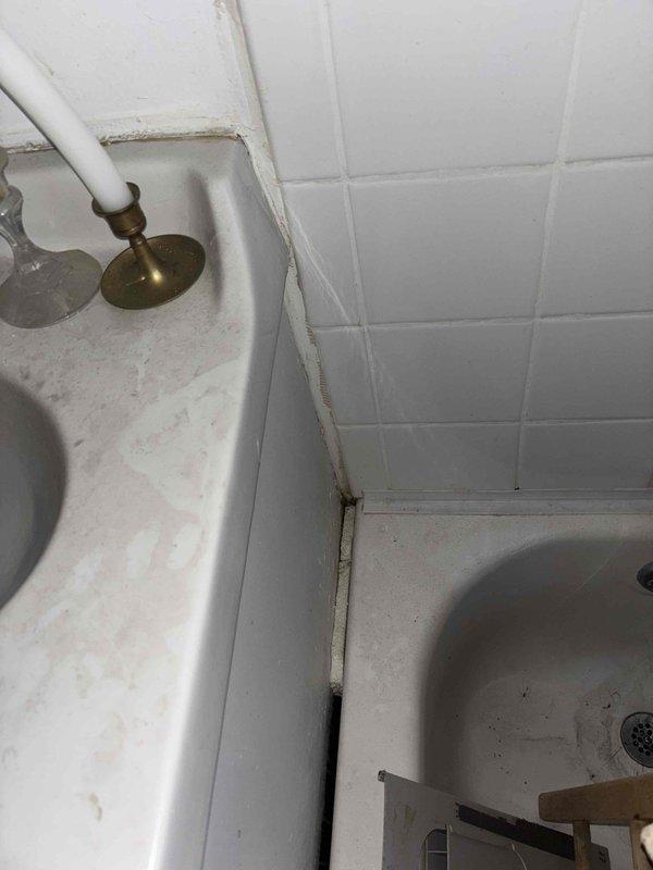 Conducted estimate for installation of dishwasher, kitchen sink, and bathroom lavatory in ground floor apartment. Inspection revealed aged bathroom fixtures with visible deterioration at wall-tile interfaces and signs of water damage. Basement assessment showed significant plumbing infrastructure concerns including deteriorated clay drain pipe, aging PVC connections, and evidence of moisture issues that will need addressing during fixture installation.