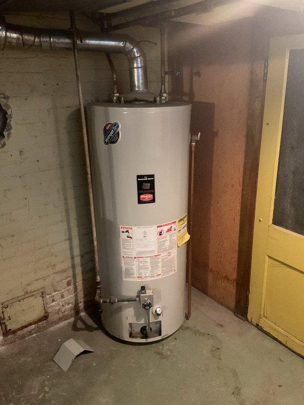 Inspected 75-gallon water heater exhibiting leakage from the bottom. Visual assessment confirmed unit is beyond its service life, with active leaking requiring replacement. Recommended installation of new water heater to prevent potential water damage and restore reliable hot water service.