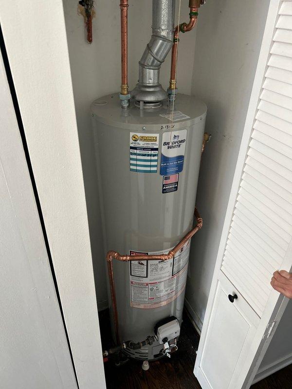 Installed 40-gallon Bradford White atmospheric water heater in residential utility closet, including complete copper pipe connection with pressure relief valve. Mounted proper venting system and verified all fittings for leak-free operation, with water alarm installed as specified.