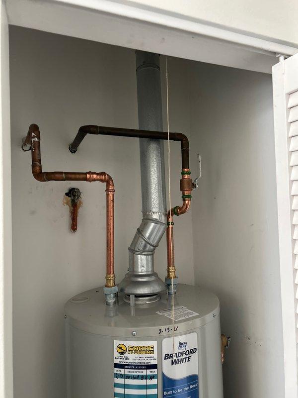 Installed 40-gallon Bradford White atmospheric water heater in residential utility closet, including complete copper pipe connection with pressure relief valve. Mounted proper venting system and verified all fittings for leak-free operation, with water alarm installed as specified.