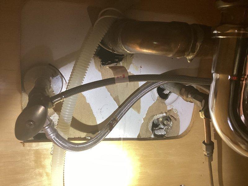 Responded to service call for burst pipe under sink. Inspected plumbing system and found damaged supply line with signs of water exposure and minor corrosion around fittings. Replaced the compromised braided supply line and checked all connections to ensure proper function and prevent future leaks.