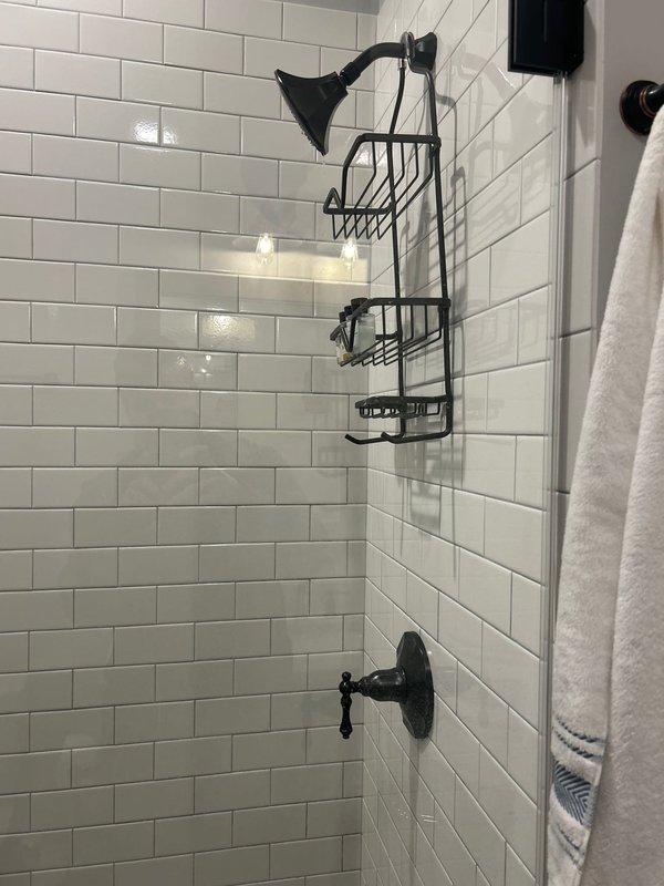 Inspected and repaired multiple shower fixtures experiencing continuous dripping, resolving leak issues through cartridge replacement and seal adjustment. Addressed bathroom faucet with low water pressure by cleaning aerator and removing mineral deposits, restoring proper flow. Additionally, cleared kitchen sink drain obstruction and sealed leaking tub base in secondary bathroom.