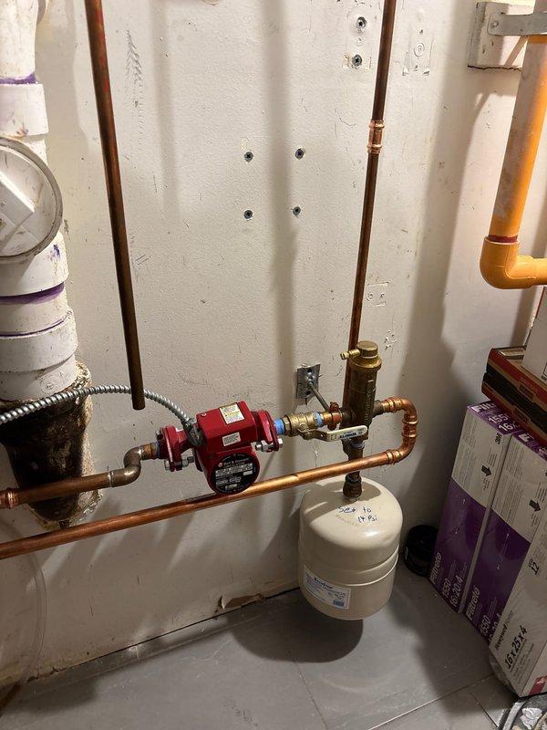 Diagnosed boiler error code issue in basement installation. Inspection revealed significant corrosion on exterior gas meter connections and piping. Serviced red circulator pump and expansion tank system to resolve error codes, ensuring proper functionality of the heating system.
