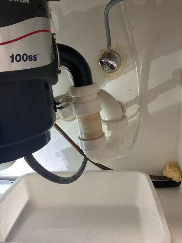 Inspected kitchen sink with reported slow drainage issue. Found minor buildup in the P-trap and drain lines connected to the 3/4 HP garbage disposal (model 100ss). Cleaned and cleared blockage, restoring proper drainage functionality to the kitchen sink.