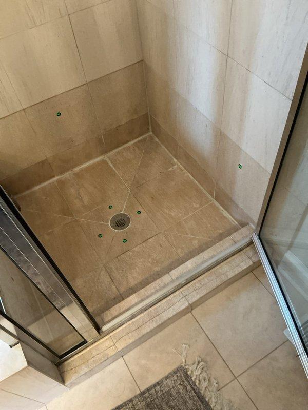 Responded to service call for shower drainage issue. Upon inspection, identified and cleared clog in central shower drain. Verified proper drainage functionality and cleaned affected area.