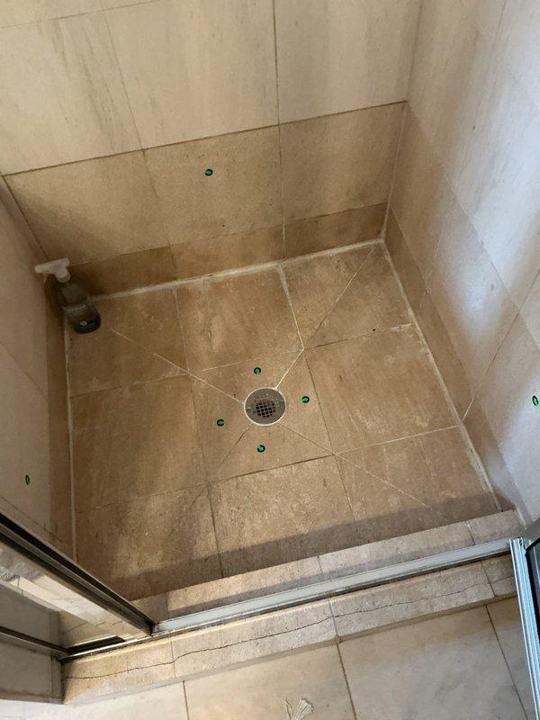 Responded to service call for shower drainage issue. Upon inspection, identified and cleared clog in central shower drain. Verified proper drainage functionality and cleaned affected area.