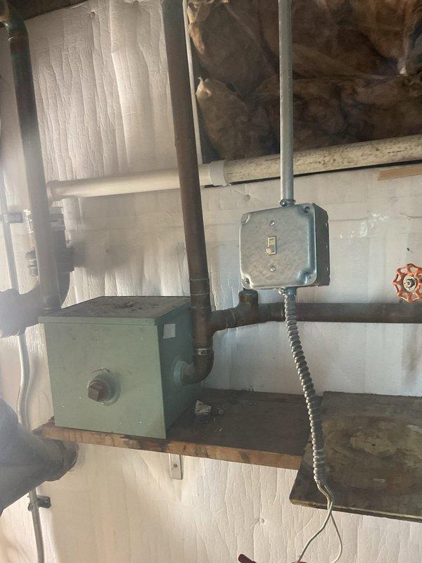 Conducted assessment of waste pump system in utility area, documenting the existing setup which includes a primary pump unit mounted on wooden platform with associated piping and electrical connections. Evaluated electrical infrastructure including dual Square D panels and junction boxes. Photos taken of complete installation for estimate purposes. Additional estimates to be provided as requested.