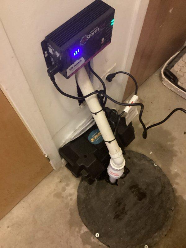 Diagnosed and serviced Ion Storm Pro 35ACi+ Battery Backup System that was beeping intermittently. Inspected sump pit containing the primary pump with float switch and battery backup system, noting sediment accumulation and mineral deposits on concrete walls. Verified system functionality with control panel showing 83% battery capacity and all indicator lights functioning properly.