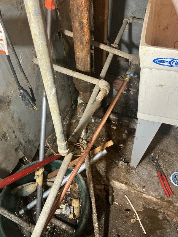 Inspected low water pressure issue affecting two faucets following previous repair work. Found significant corrosion in copper supply lines and evidence of moisture damage on surrounding walls. Cleaned sediment from affected lines and replaced corroded pipe sections to restore proper water flow to all fixtures.