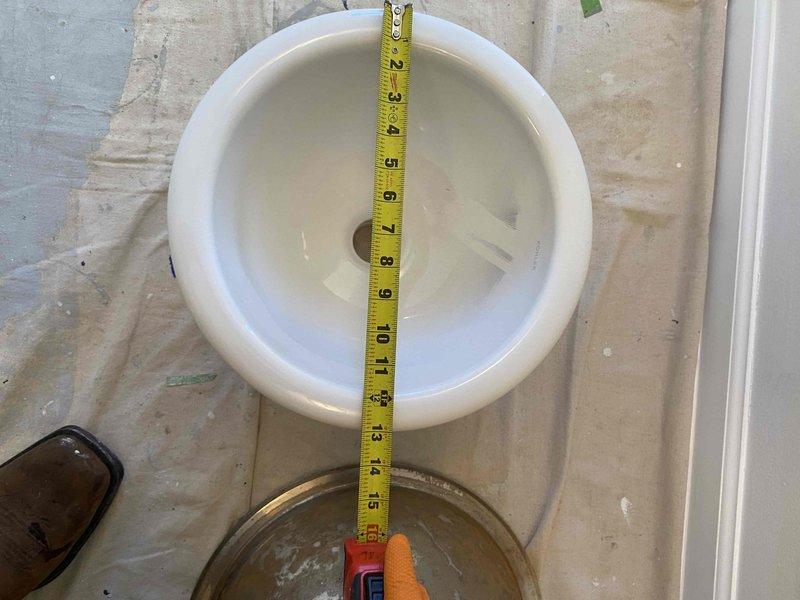 Successfully returned to the property to complete the previously sold installation of under-mount sinks. Installed white porcelain toilet and measured ceramic bathroom basin (approximately 15 inches) to ensure proper fit during renovation. All fixtures were verified to be in proper working order before completion.