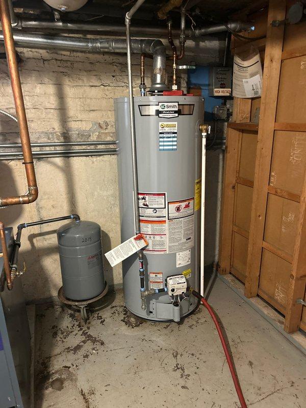 Performed annual VIP maintenance on A.O. Smith water heater system, including inspection of expansion tank, copper/PVC connections, and drainage components. Checked all plumbing connections for leaks, verified proper system pressure, and examined floor access point where utility pipes pass through to ensure proper sealing and function.