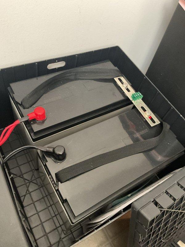 Performed inspection of commercial grease trap system and associated sewer line as requested. Observed significant deterioration and cracking around access point, standing water with visible debris, and signs of rust/corrosion at pipe connections. Backup power system with dual batteries appears to be functioning normally with proper connections and secure mounting.