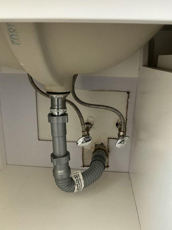 Responded to service call regarding a bathroom faucet leak reported to have started several months prior. Inspected undermount sink with widespread chrome faucet set in marble countertop. Customer had replacement faucet available if needed. Visual inspection of plumbing revealed gray plastic P-trap assembly with corrugated flexible piping and braided supply lines in good condition.