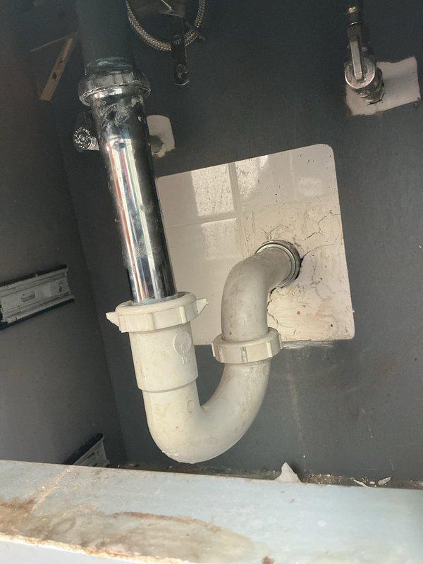 Responded to callback regarding previous rodding service where drain pipes were not properly reattached. Reinstalled and secured PVC P-trap assembly under sink with proper connections to both the tailpiece and wall drain. Inspected and resolved water pressure issue by cleaning aerators and checking supply lines for restrictions.