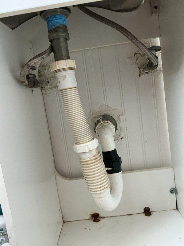 Responded to callback regarding previous rodding service where drain pipes were not properly reattached. Reinstalled and secured PVC P-trap assembly under sink with proper connections to both the tailpiece and wall drain. Inspected and resolved water pressure issue by cleaning aerators and checking supply lines for restrictions.