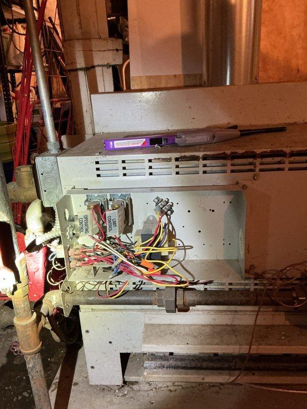 Responded to service call regarding no hot water in commercial building. Upon inspection of the HVAC/boiler system, observed aging copper piping with surface corrosion, a circulation pump with red motor component, and examined the internal wiring and components of the heating unit. Diagnostic assessment performed on the 50-gallon water heater which had failed the previous day.