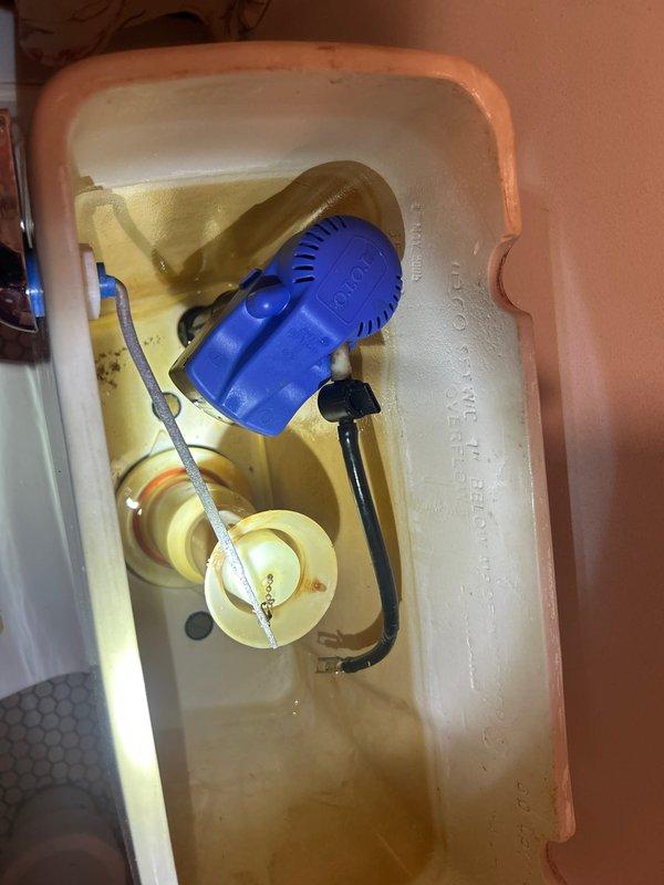 Responded to service call for two toilet issues: main floor toilet with flushing problems and basement toilet with broken handle. Upon inspection, found worn flush valve assembly in main floor toilet dated from 2003 with significant mineral buildup. Replaced flush valve components and adjusted water level for proper operation; also replaced broken handle mechanism in basement toilet, testing both units to confirm complete resolution of reported issues.