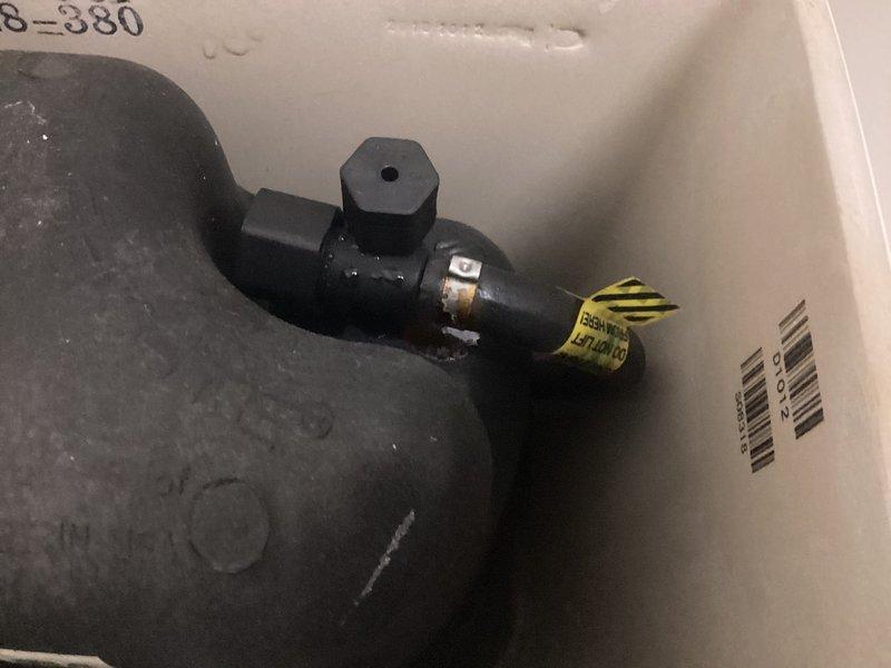 Responded to service call for toilet leaking from underneath. Upon inspection, removed toilet to access the flange area which showed signs of previous installation work and sealant residue. Replaced deteriorated wax ring seal with new rubber gasket, ensuring proper installation with the yellow caution ring positioned correctly, then reinstalled and secured toilet to prevent future leakage.
