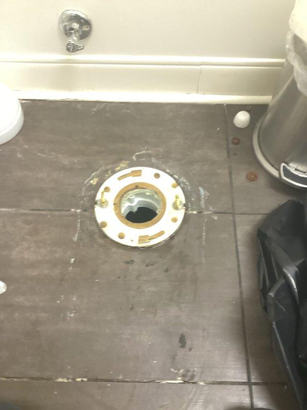 Responded to service call for toilet leaking from underneath. Upon inspection, removed toilet to access the flange area which showed signs of previous installation work and sealant residue. Replaced deteriorated wax ring seal with new rubber gasket, ensuring proper installation with the yellow caution ring positioned correctly, then reinstalled and secured toilet to prevent future leakage.