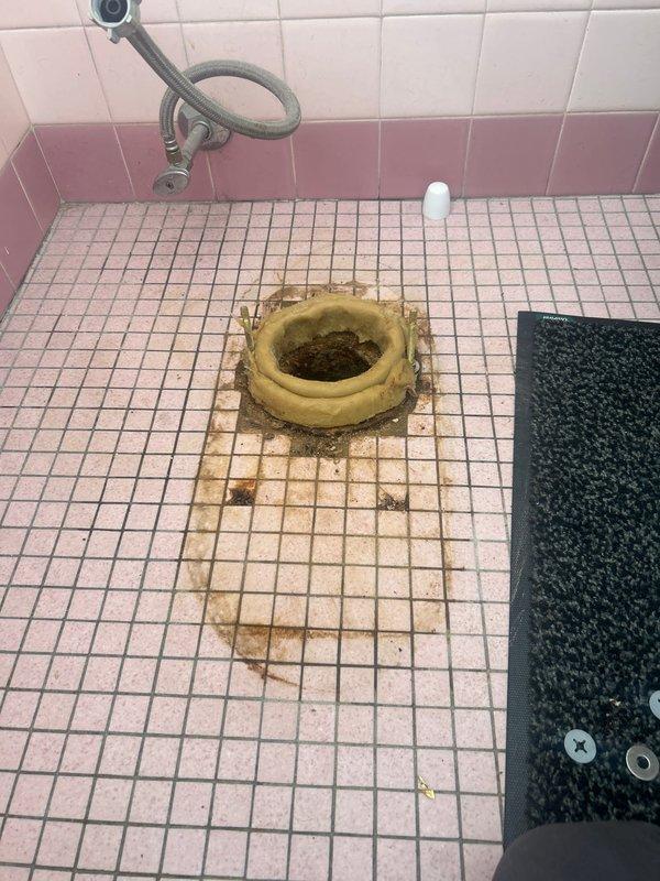 Performed toilet replacement service originally sold by Jon. Upon inspection, identified significant water damage and staining around the existing toilet flange, with visible discoloration extending to surrounding floor tiles. Successfully removed old toilet and wax ring, then installed new toilet fixture with proper sealing to prevent future leakage.