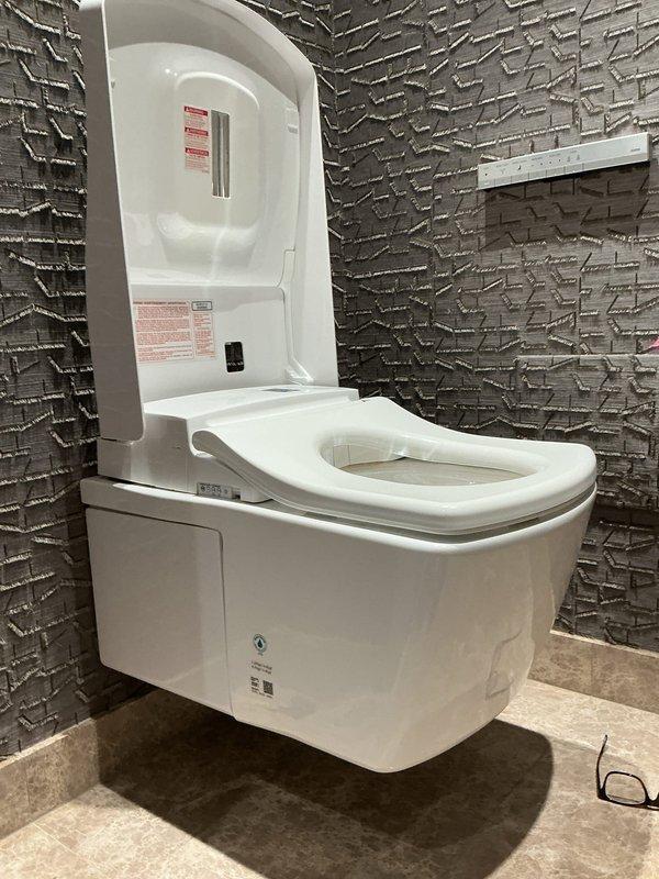 Diagnosed and repaired high-end Toto wall-mounted toilet system (Model AC SN996MX EW SN994M) that was non-operational with both flushing mechanism and bidet functions failing. Identified faulty electronic control valve assembly, which was replaced to restore full functionality to both toilet flush and integrated bidet features.
