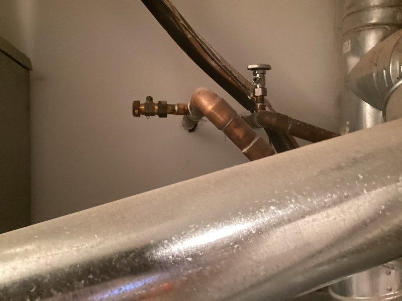 Completed copper pipe repair in utility area, replacing damaged sections and installing new shut-off valve. System now functions properly with no leaks at connection points and proper flow through the newly installed components.