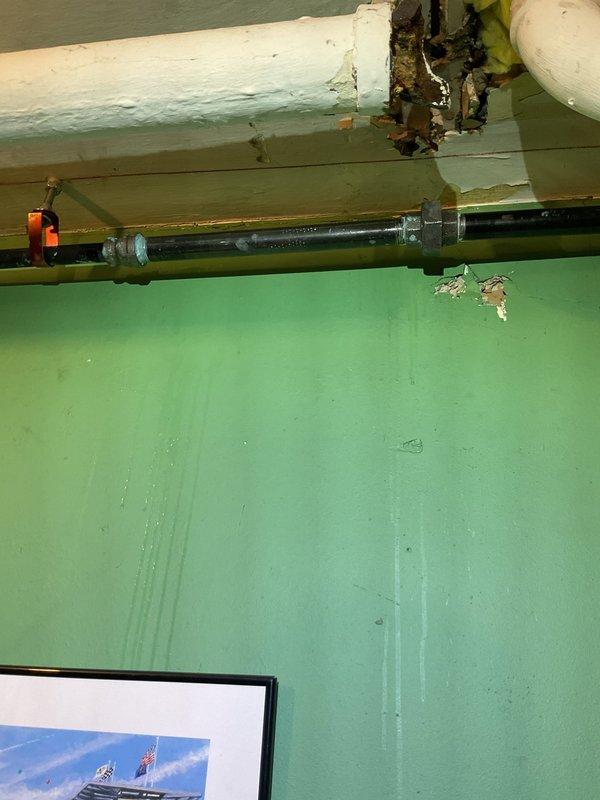 Responded to a natural gas leak report in century-old residential property, with issue persisting for approximately one week. Conducted comprehensive inspection revealing significant deterioration at pipe junction in ceiling area with visible material breakdown and wall staining indicating prolonged exposure. Performed pressure testing on the gas line system, replaced damaged section of piping with appropriate fittings and mounting brackets, and verified system integrity before restoring service.