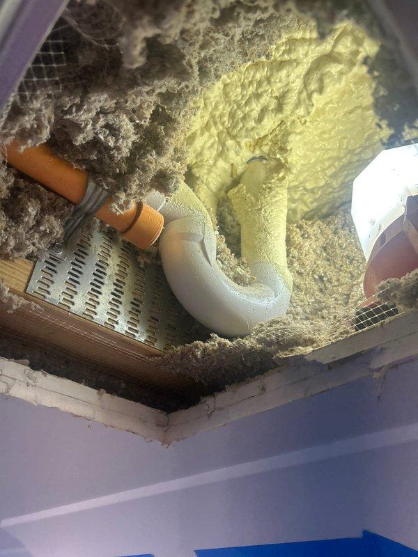 Responded to water leak in 3-year-old condo affecting ceiling area. Inspection revealed compromised PVC elbow joint connection with copper pipe, with deteriorating insulation surrounding the affected area. Repaired plumbing connection, replaced damaged section, sealed joints properly, and restored insulation to prevent future leakage.