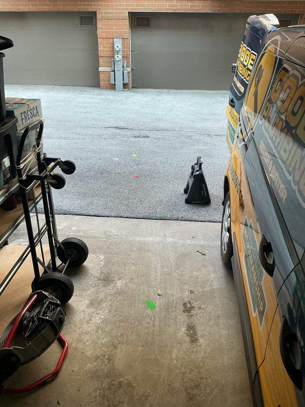 Attended property to assess and provide estimate for removal of an 11-foot belly in sewer line. Took detailed photographs of the work area including the courtyard access point and garage workspace to document site conditions for proper equipment and resource planning.