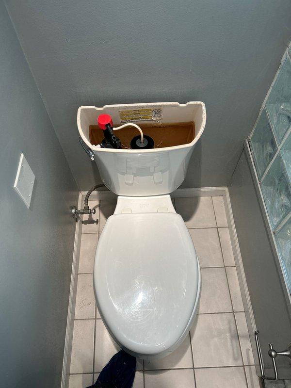 Responded to service call for toilet not filling properly. Upon inspection, removed tank lid to examine internal components, revealing a malfunctioning fill valve with significant mineral buildup. Cleaned and adjusted the fill valve assembly, replaced worn flapper, and verified proper water level and flush operation before completing the service.
