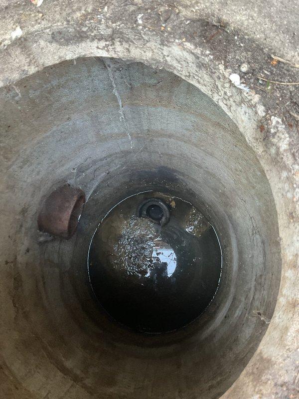 Responded to service call for toilet backing up and draining slowly. Inspection revealed blockage in drainage system with accumulated debris and standing water in the main sewer access point. Cleared obstruction and restored proper drainage function to toilet system.