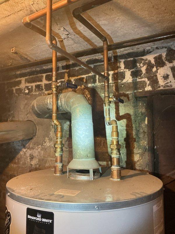Performed scheduled maintenance on Bradford White tanked water heater per afternoon appointment request. Conducted thorough system flush to remove sediment buildup and inspected all connections, valves, and venting components. Confirmed proper operation of unit with functional exhaust flue and verified integrity of copper supply lines and fittings.