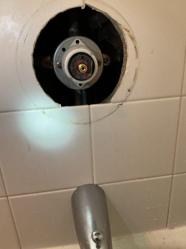 Completed shower valve repair originally sold by technician. Removed faulty valve assembly from tiled wall enclosure, replaced worn O-rings and brass fittings, and reinstalled properly. Ensured proper function and verified no leaks after installation.