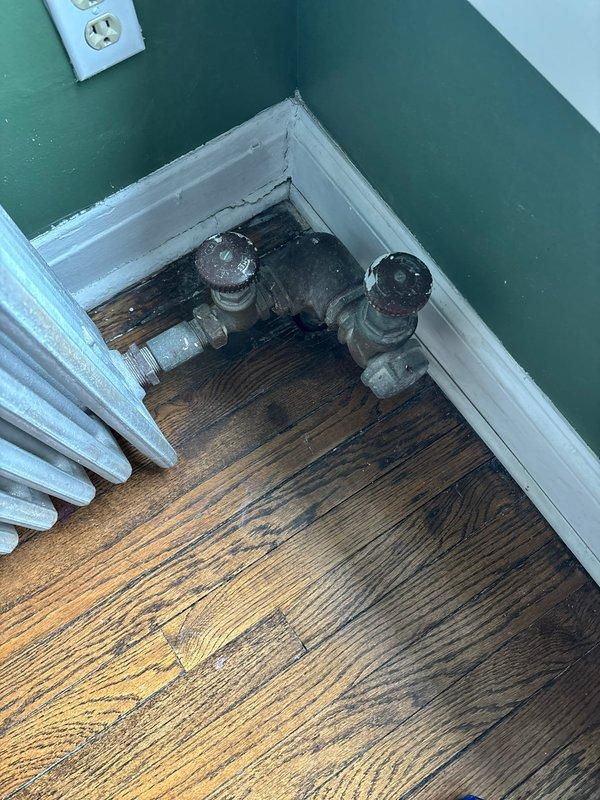 Responded to service call regarding noisy radiators in multi-unit condo. Inspected column-style radiator exhibiting hissing and clanking noises. Identified air trapped in system and performed bleeding procedure on radiator valves to release excess air, restoring proper operation and eliminating noise issues.