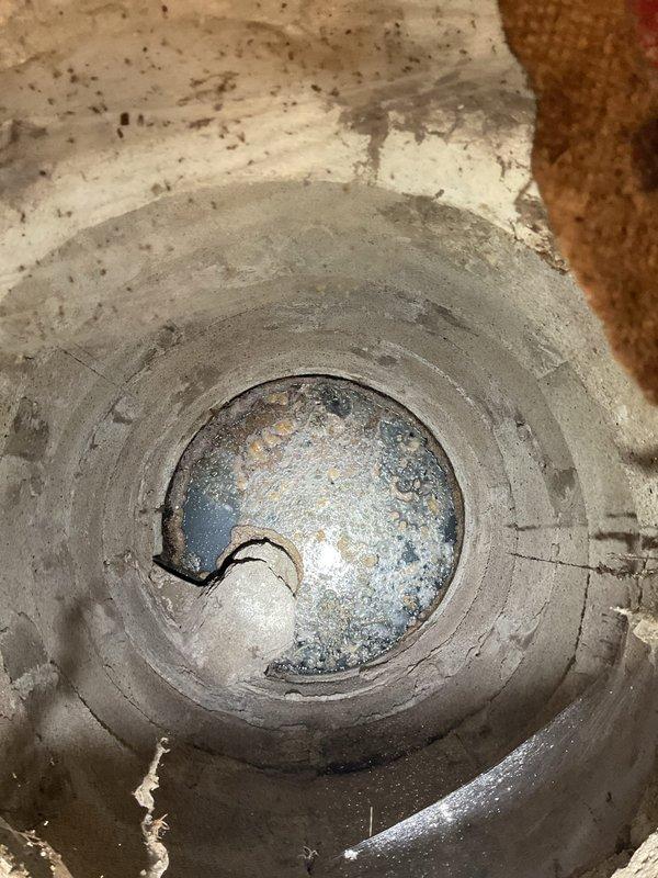 Performed inspection of flood control system in response to drainage issues. Located circular concrete pipe with standing water showing mineral deposits and rust. Cleaned out flood control valve which was impeding proper drainage function. Recommended client consult with plumber to locate and address pump connected to PVC line, disconnect it from parkway discharge point, and service the entire flood control system to prevent future backups.