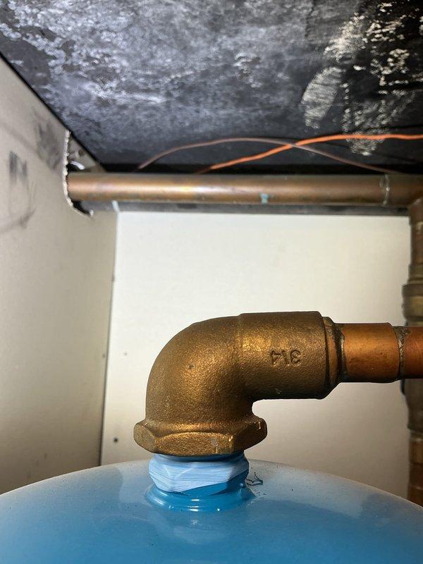 Conducted assessment for replacement of lead water service line with copper piping. Evaluated current water shut-off location in private area and determined relocation requirements to make it accessible to entire building, potentially in a vault installation. Documented existing plumbing configuration including brass fittings and current pipe routing for comprehensive replacement planning.