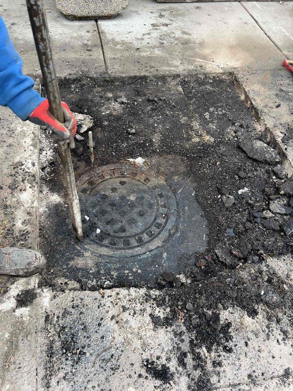 Excavated concrete surrounding manhole access point to expose main sewer line connection. Installed new toilet supply line with proper braided metal hose and verified secure connections at both the wall valve and tank fitting.