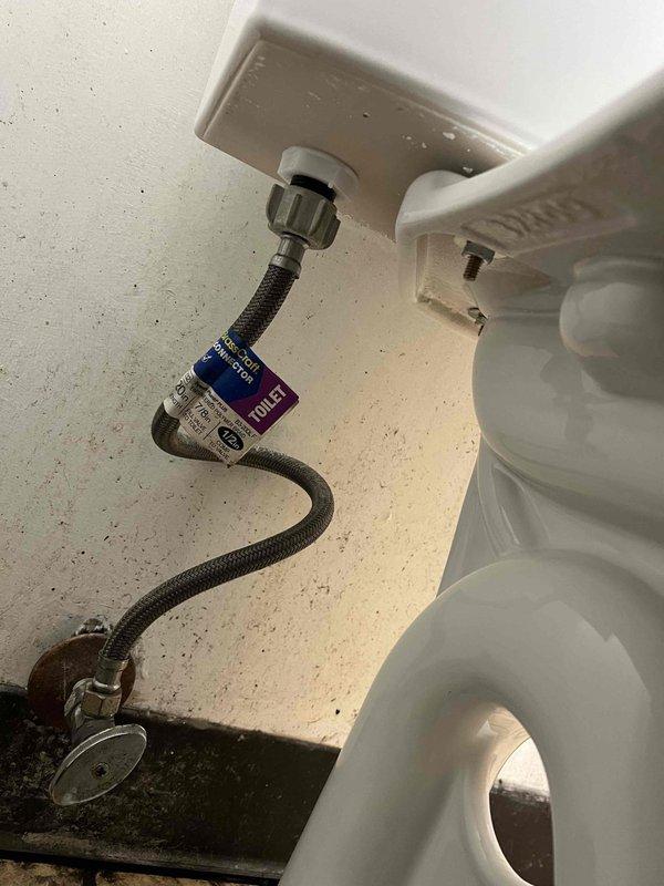 Excavated concrete surrounding manhole access point to expose main sewer line connection. Installed new toilet supply line with proper braided metal hose and verified secure connections at both the wall valve and tank fitting.