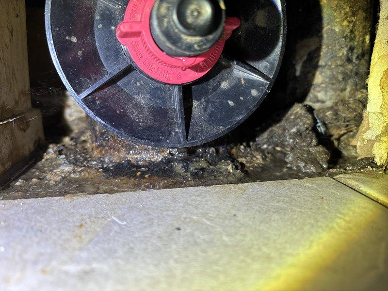 Responded to emergency service call regarding persistent leak following previous service. Upon inspection, discovered deteriorated valve assembly with significant mineral buildup and water damage in wall access point. Replaced faulty shut-off valve, installed new seal, and verified proper operation with no leaks present.