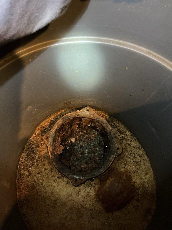Responded to service call regarding basement floor drains backing up. Upon inspection, discovered severely corroded drain components with significant rust and mineral deposits affecting drainage performance. Serviced the affected plumbing system and verified proper sump pump operation to resolve the week-long backup issue.