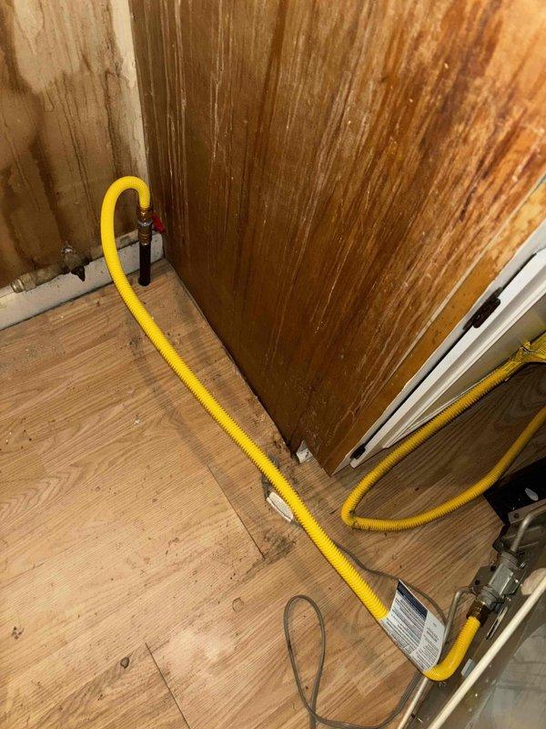 Collected down payment for repair work pertaining to water damage remediation. Documented extensive water damage in the utility area, including ceiling mold/mildew growth, deteriorated wooden structures, and water-stained wall paneling. Identified flexible gas line installation and assessed condition of associated fittings.