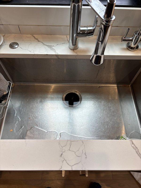 Responded to priority service call for a kitchen sink clogged line requiring snaking in a 6-year-old home. Performed drain cleaning service on stainless steel undermount sink with visible water backup. Successfully cleared the persistent clog that had been problematic for one week, restoring proper drainage function.