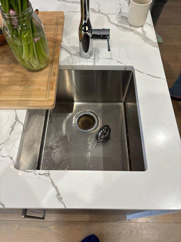 Responded to priority service call for a kitchen sink clogged line requiring snaking in a 6-year-old home. Performed drain cleaning service on stainless steel undermount sink with visible water backup. Successfully cleared the persistent clog that had been problematic for one week, restoring proper drainage function.