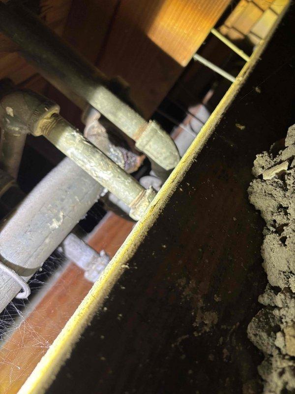 Repaired a pipe with puncture damage caused by previous contractor's work. Inspected the affected area, revealing significant corrosion at connection points. Restored proper function by replacing damaged section and securing joints, preventing further water leakage after temporarily shut-off water had been restored.