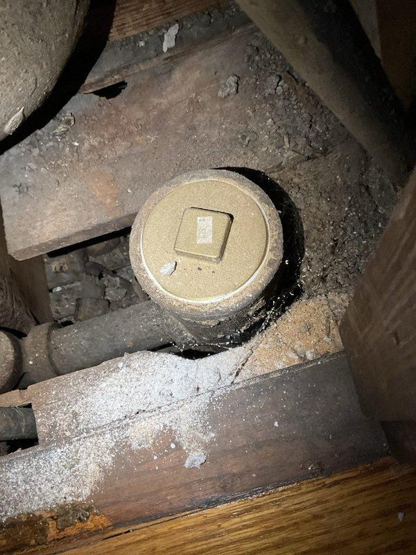Responded to service call for bathroom drain clog. Accessed plumbing cleanout located in confined crawlspace area with significant dust accumulation. Successfully cleared obstruction in drain line, restoring proper drainage function to bathroom fixture.