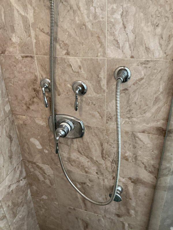 Inspected customer-purchased shower cartridge for compatibility with existing multi-function shower system. Verified correct specifications and successfully installed cartridge in the chrome valve assembly. System now functioning properly with all diverter functions operational between main showerhead and handheld unit.