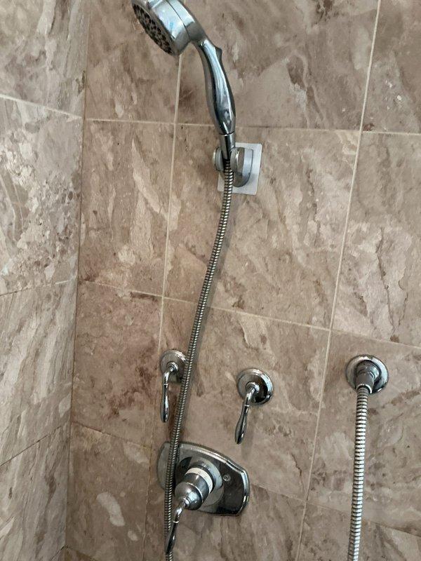 Inspected customer-purchased shower cartridge for compatibility with existing multi-function shower system. Verified correct specifications and successfully installed cartridge in the chrome valve assembly. System now functioning properly with all diverter functions operational between main showerhead and handheld unit.